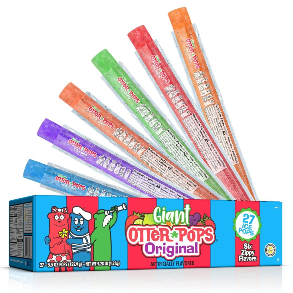 A box of Giant Otter Pops Original ice pops is shown with six colorful, individually wrapped popsicles fanned out above it. The box features cartoon otters and advertises 27 pops in six zippy flavors.